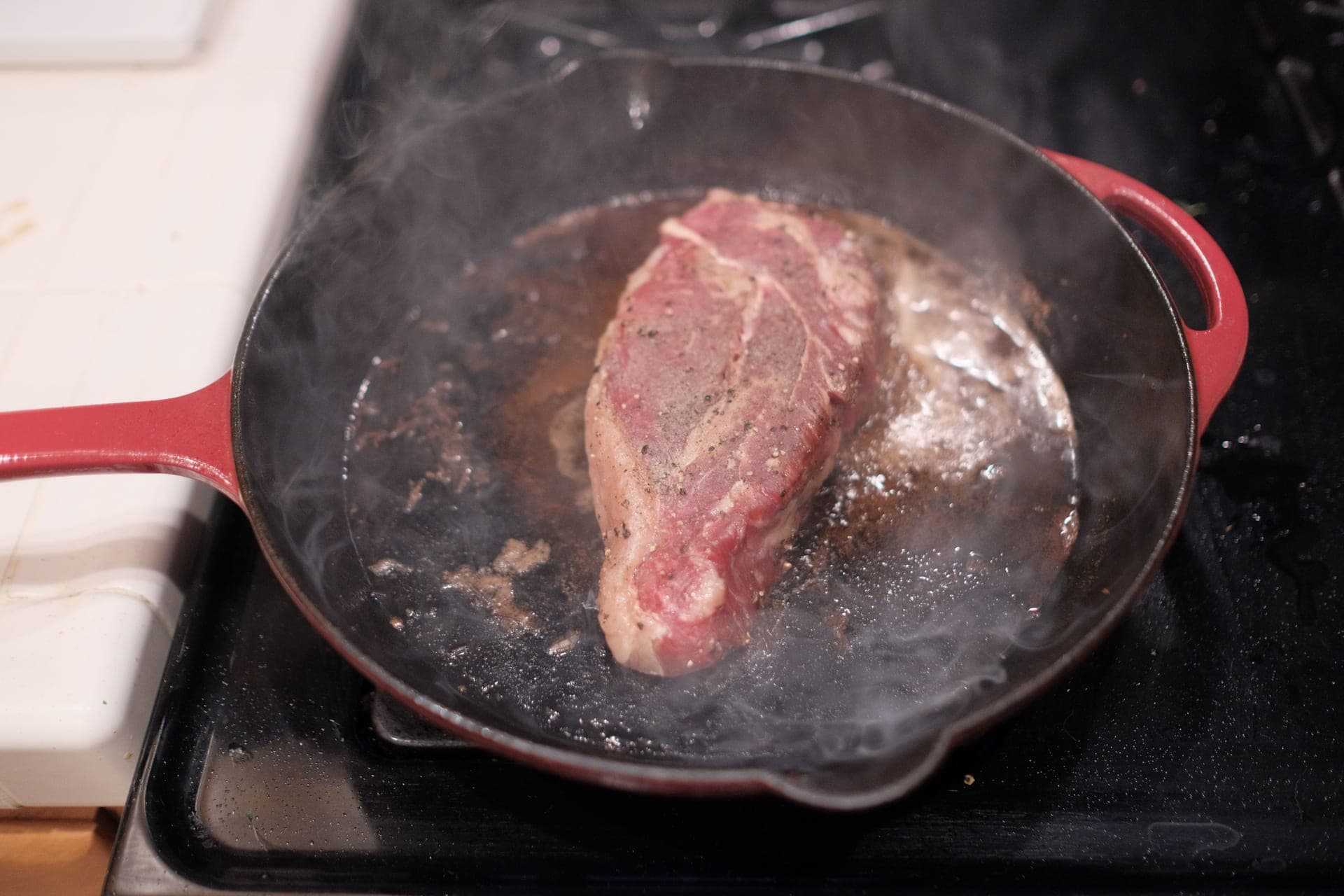A well-seasoned cast iron skillet on a warm hearth